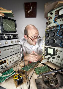 Pensive scientist working at vintage technological laboratory