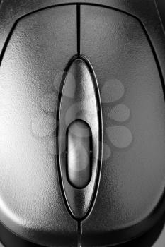 Computer mouse on reflective grey surface. In B/W