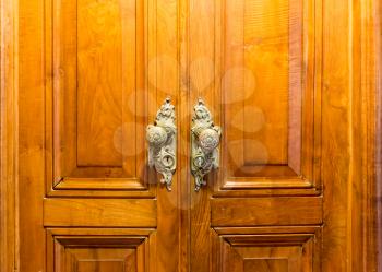 Close up of vintage wooden door with two handles