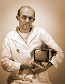 Portrait of pensive scientist with vintage monitor. Sepia toned