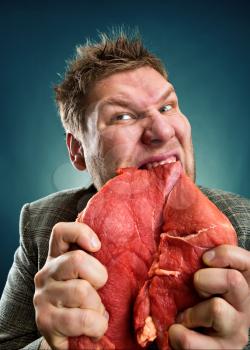 Crazy businessman with raw meat