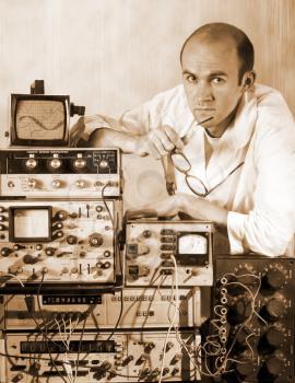 Portrait of pensive scientist at vintage technological laboratory. Sepia toned