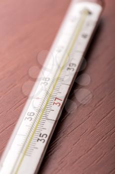 Thermometer on a wooden table closeup