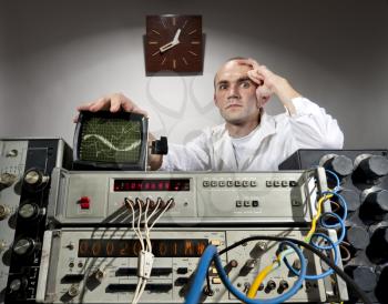 Pensive scientist working at vintage technological laboratory