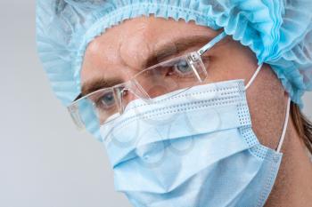 Portrait of sweat serious surgeon in surgical mask