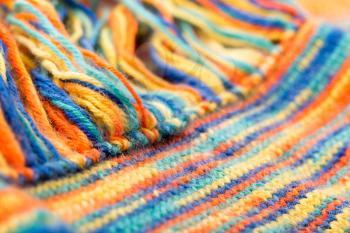 Knitted multicolored scarf with fringes closeup