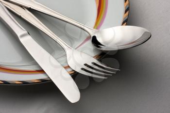 Dinner set. Fork, spoon and knife on plate