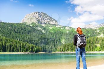 Woman with backpack on the lake, Durmitor National Park, Montenegro