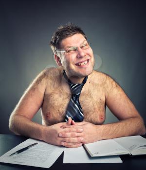 Smirking shirtless businessman studio image