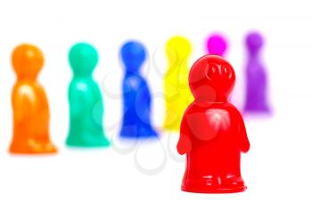 Standing out of the crowd concept. Colorful toy people group on white