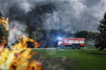 Fire-engine is in hurry to extinguish dangerous fire in the forest