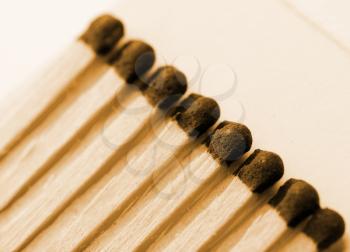 Close-up view of wooden matches in matchbook. Sepia toned