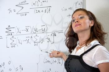 Attractive mathematics teacher in classroom