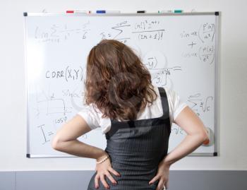 Student at blackboard in classroom