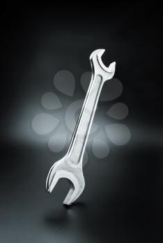 Stainless steel wrench on dark background