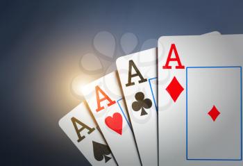 Closeup of four aces on dark background