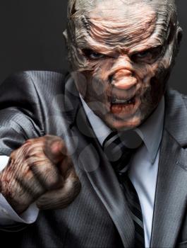 Angry monster in business suit pointing to you