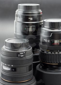 Close-up of three different professional camera lenses