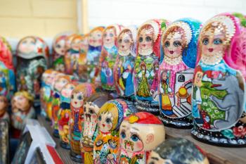Many colorful russian dolls in a rows