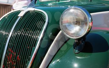 Close up of head-light of the retro green car