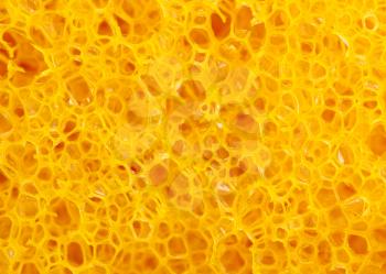 Close-up of yellow cleaning sponge. Background or texture