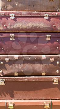 Background of the heap of old brown suitcases 