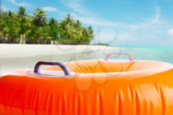 Inflatable orange bath cushion on the beach