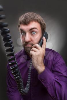 Adult bearded man speaks on the phone 