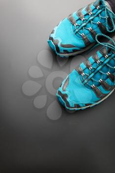 Blue running shoes on grey background