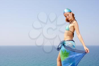 Beautiful woman with seascape on background