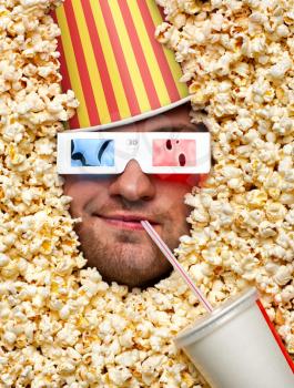 Happy face in popcorn with bucket on head watching 3D movie and drinking soda