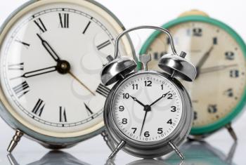 Three old classical alarm clocks
