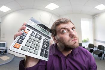 Accountant holds calculator in the office