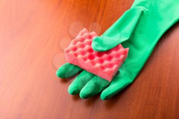 Cleaning glove with a red sponge on the table