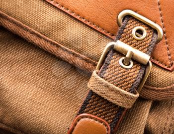 A closeup of brown backpack buckle