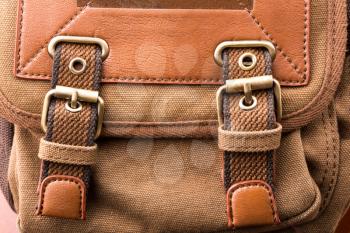 A close up of brown backpack buckle