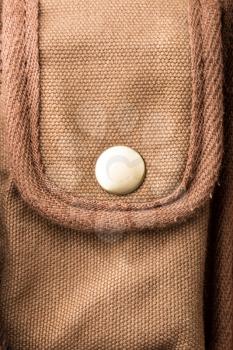 White button on brown pocket