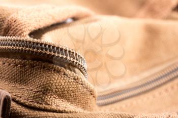 Closeup of brown bag with open zipper