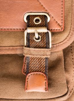 A closeup of vintage brown backpack buckle