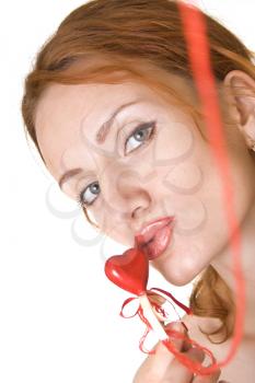 Beautiful woman kissing the red heart