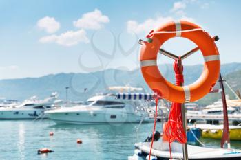 Lifebuoy in sea port against yachts