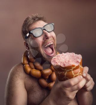 Hungry man with sausages round his neck eats a big wurst 
