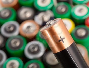 Closeup of battery against many other batteries