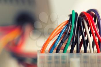 Closeup of electrical plug with colorful cables