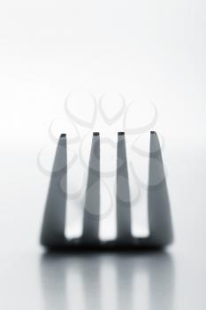 Closeup of silver fork on white background