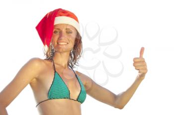 Tan woman in christmas hat showing OK sign. Isolated on white