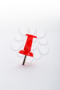 Red pushpin closeup isolated on white background