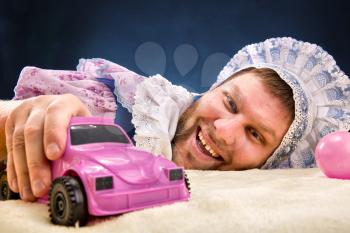 Man weared as baby with toy car