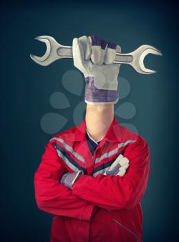 Worker with hand holding spanner instead of head