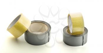 Four rolls of adhesive tape on white background